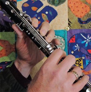 hands playing clarinet closeup